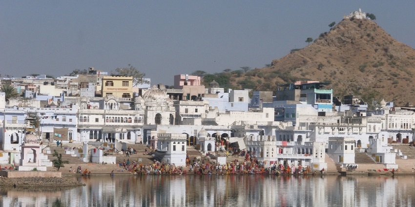 A serene view of the bathing ghats, with steps leading down to the calm waters.