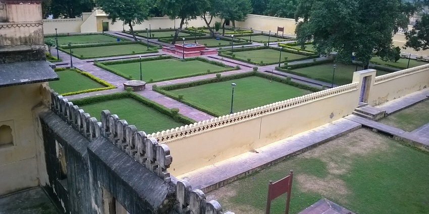 A view of the park inside Abheda Mahal in Kota with a serene garden and lush green lawns.