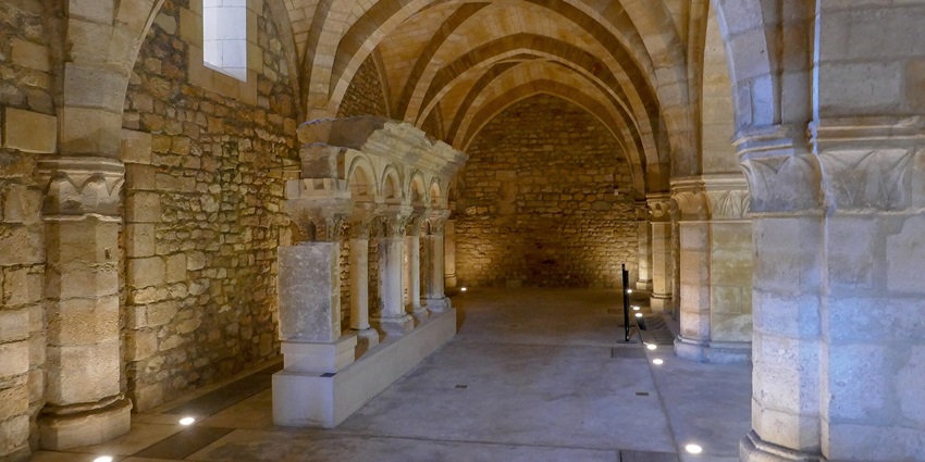 A stunning interior view of a palace with brown walls and low lights during the daytime.