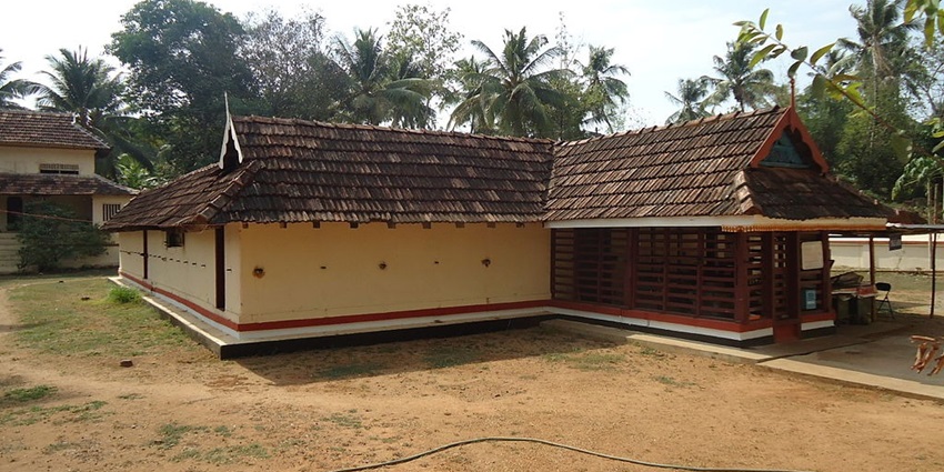 A stunning view of a temple with red and brown architecture during the daytime for all.