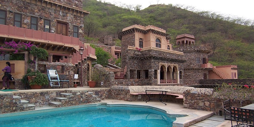 A beautiful view of Neemrana Fort Palace, featuring its pool and historic architecture.