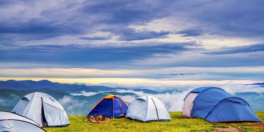 Image of camping site on top of the mountain under white clouds and blue sky - camping in Dharamshala