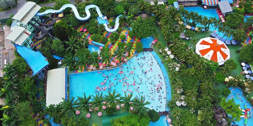 Visitors enjoying various adventurous water rides at Adventure Island, a popular water park in Alwar.