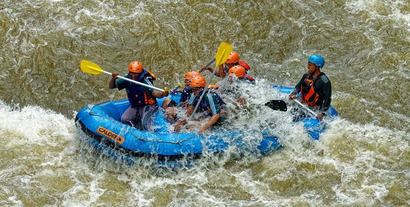 A breathtaking view of a few men enjoying river rafting in a body of water during the day.