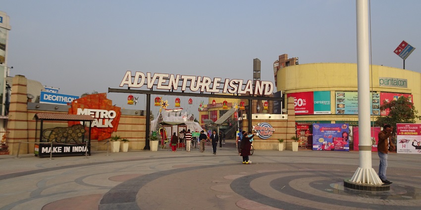 A stunning frontal view of a board saying Adventure Island in bold during the daytime.