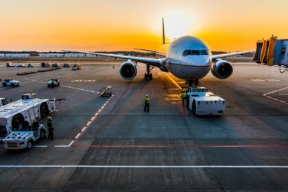 A quaint view of an aeroplane on the runway ready to fly with a picturesque backdrop.