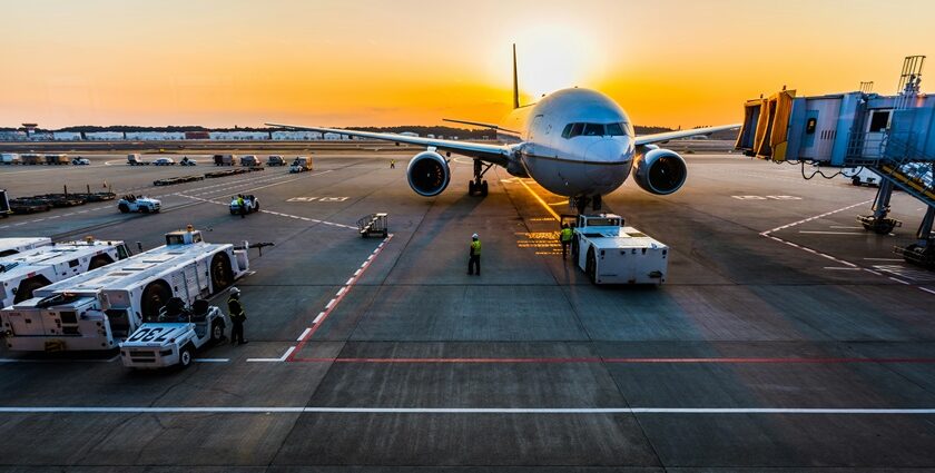 A quaint view of an aeroplane on the runway ready to fly with a picturesque backdrop.