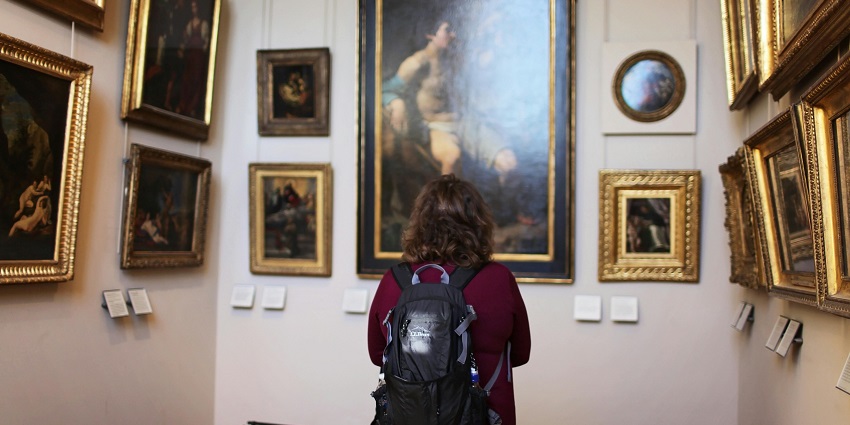 A woman observing the modern art and photography exhibitions