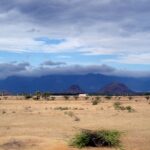 A picture of a scenic landscape of desert land and mountains in the background