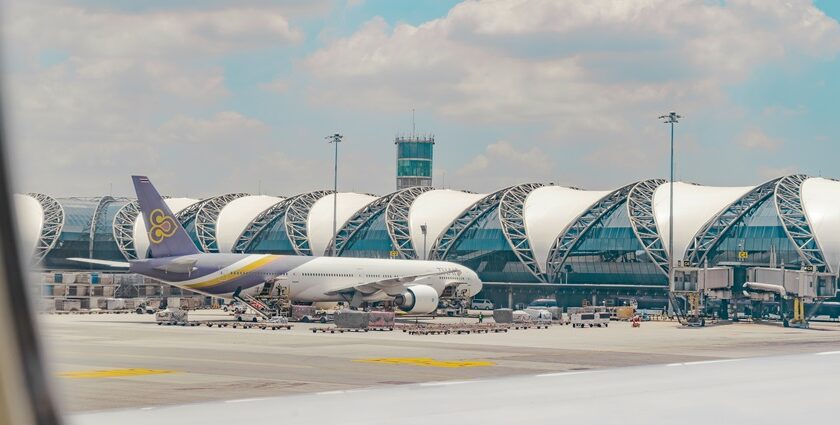 Breathtaking view of an airport with a plane around stunning architecture during the day.