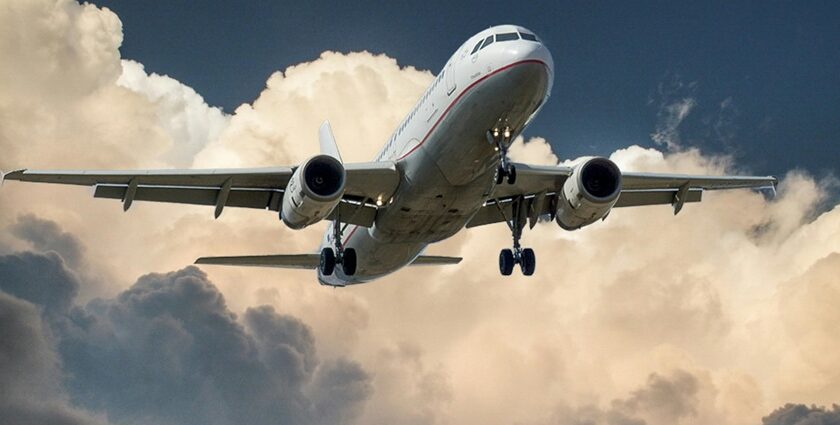 Breathtaking view of a red and white aeroplane surrounded by dense clouds during the day.