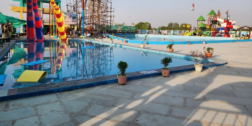 Image of fun-filled water rides and pools at water park in a sunny day and summer