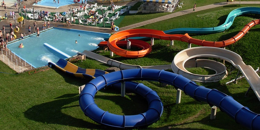 Aerial view of a water park with adventurous rides and many other activities in the park