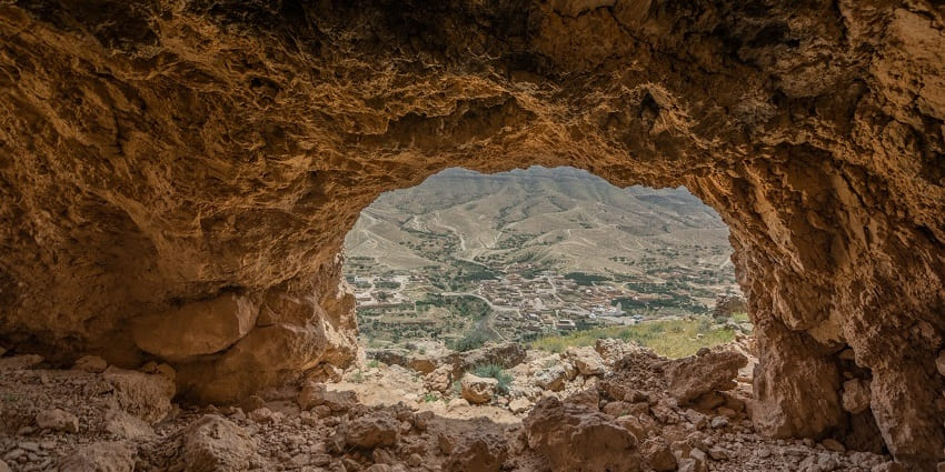 A picturesque village nestled inside the mountain range of Orbata, showcasing rustic charm and natural beauty.
