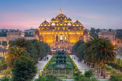 An image of the beautiful Akshardham Temple at night showcasing the water and laser shows.