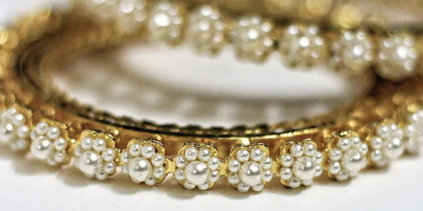 A stack of gold and diamond bracelets displayed at Alankar Jewellers.