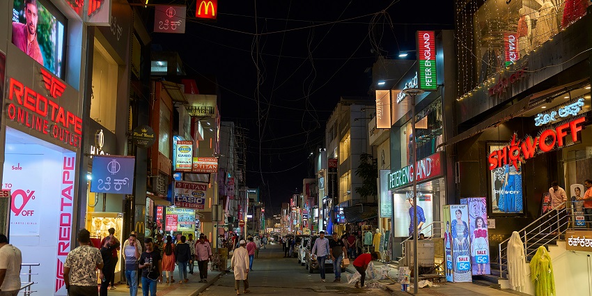 Vibrant street of the arcade at night, with the diverse clothes available at different shops