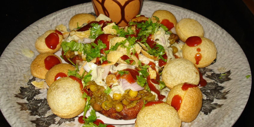 Aloo tikki chaat served with tamarind and mint chutney garnishes with sev and pomogranet