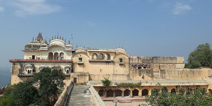 Distant view of the Ajmer fort from the front, surrounded by lush greenery