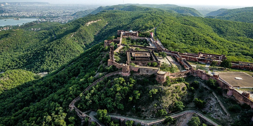 An aerial view of Amagarh Fort in Jaipur, Rajasthan with scenic greenery all around