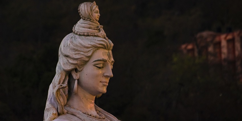 An image showing the grand statue of Lord Shiva, depicted in a seated meditation pose.