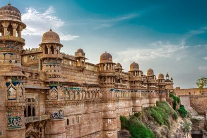 Concrete structure of Gwalior Fort, with historic architecture in the background.