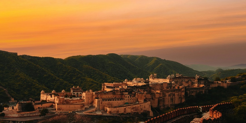 Amber Fort glowing in golden sunset light, a popular destination near Sunshine Water Park
