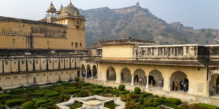 Amber Fort bathed in golden hues at sunset, a must-see among tourist places in Jaipur.