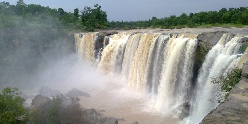 The stunning Amritdhara Waterfall surrounded by lush greenery, near Sitamani Temple.