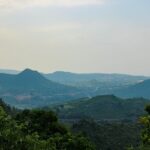 A breathtaking view of a lush green valley in Andhra Pradesh during the daytime.