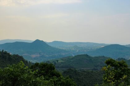 A breathtaking view of a lush green valley in Andhra Pradesh during the daytime.