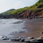 A breathtaking vista of glistening waters meeting the pristine golden sands at the beach.