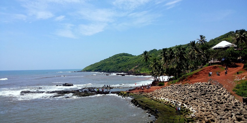 A scenic view of the serene Anjuna Beach, one of the best places to visit in Goa in July.