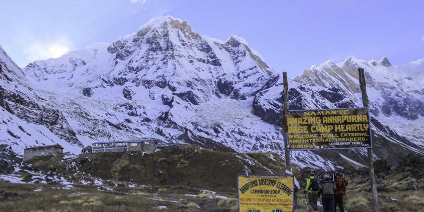 Scenic view of Annapurna Base Camp with snow-capped mountains, rocky terrain, and clear blue skies, a famous bungee jumping location in Pokhara.