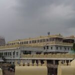 A picture of an ancient temple in Annavaram with tall buildings in the premises