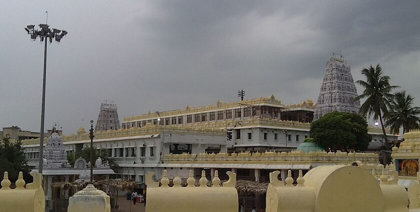 A picture of an ancient temple in Annavaram with tall buildings in the premises