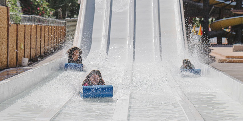 Families enjoying the wave pool and slides at Aqua Adventure Park, one of the top water parks in Alwar.