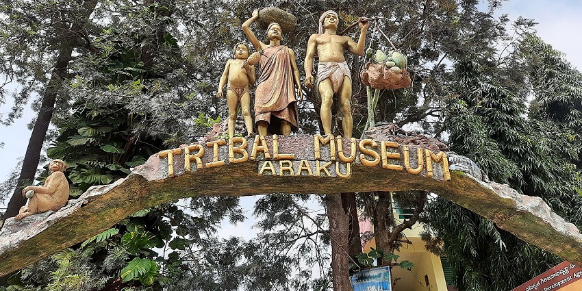 A picture of an entry gate of a tribal museum in Araku with sculptures of tribal people on top