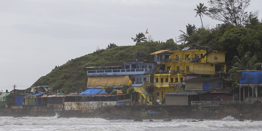 A scenic view of Arambol Mountain with lush greenery overlooking the vast Arabian Sea.