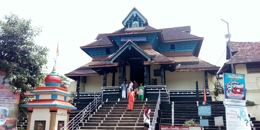 The Aranmula Parthasarathy Temple's intricate architecture and towering spires, surrounded by greenery.