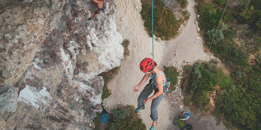 Girls in helmets climbing in Aravalli Adventure Camp, among adventure parks in Ajmer.