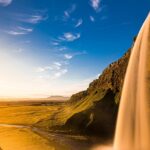 A stunning landscape featuring cascading Arvalem waterfalls surrounded by lush greenery