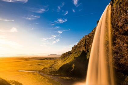 A stunning landscape featuring cascading Arvalem waterfalls surrounded by lush greenery