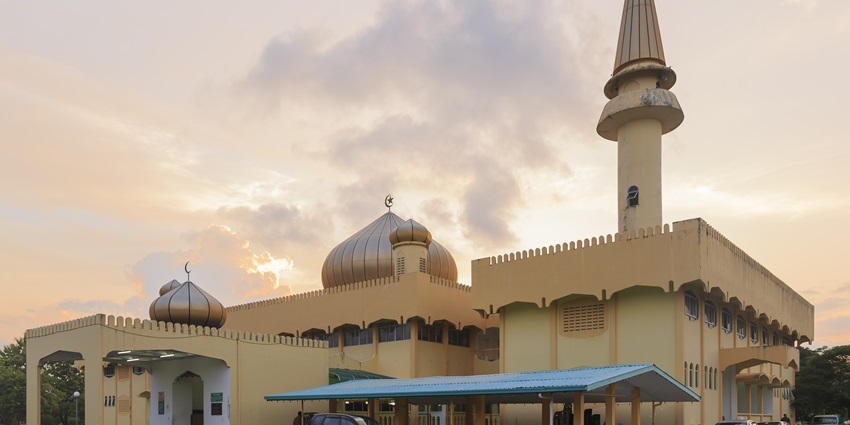 Modern mosque near Petronas Towers with steel dome, Persian-inspired design, and peaceful ambiance in Kuala Lumpur City Centre Park.