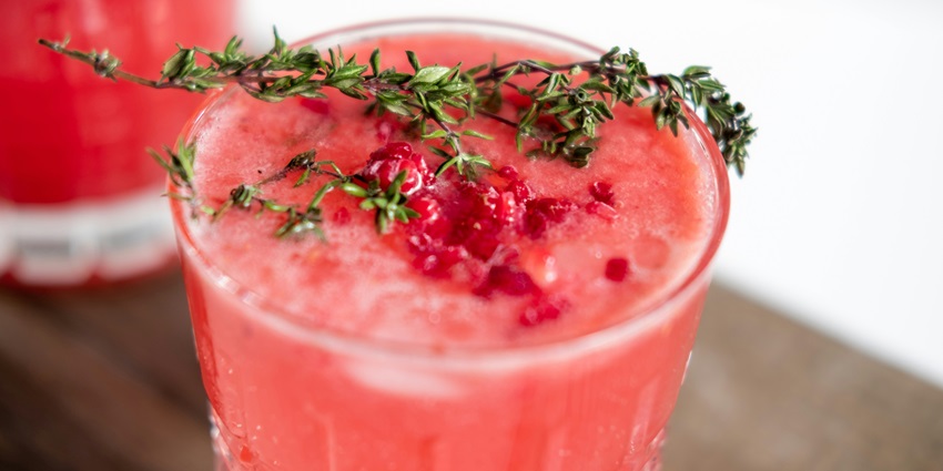 A picture of a raspberry cocktail served chilled with lime at a bar in Ko Samet