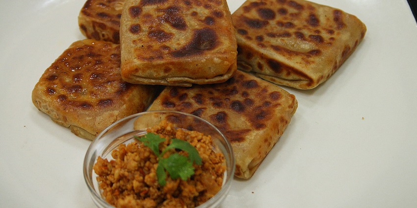 sanp of the mughlai keema paratha and the paneer in a bowl is served in a Restaurant