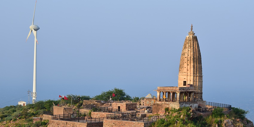 Ancient Shiva temple features intricate carvings and serene landscapes for worship.