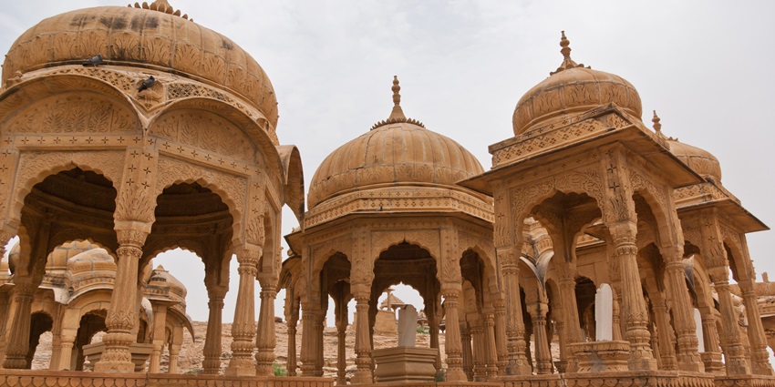 Bada Bagh sandstone cenotaphs with roofs and intricate carvings in a desert landscape