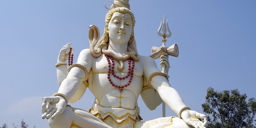Majestic statue of Lord Shiva, depicted in a seated meditative posture with a serene expression.