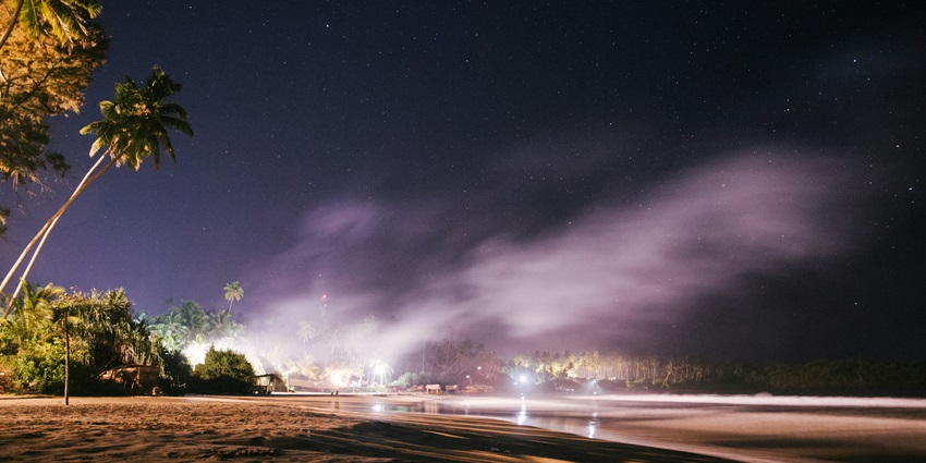 An aerial view of the scenic Baga Beach, one of the top places to visit in Goa at night.